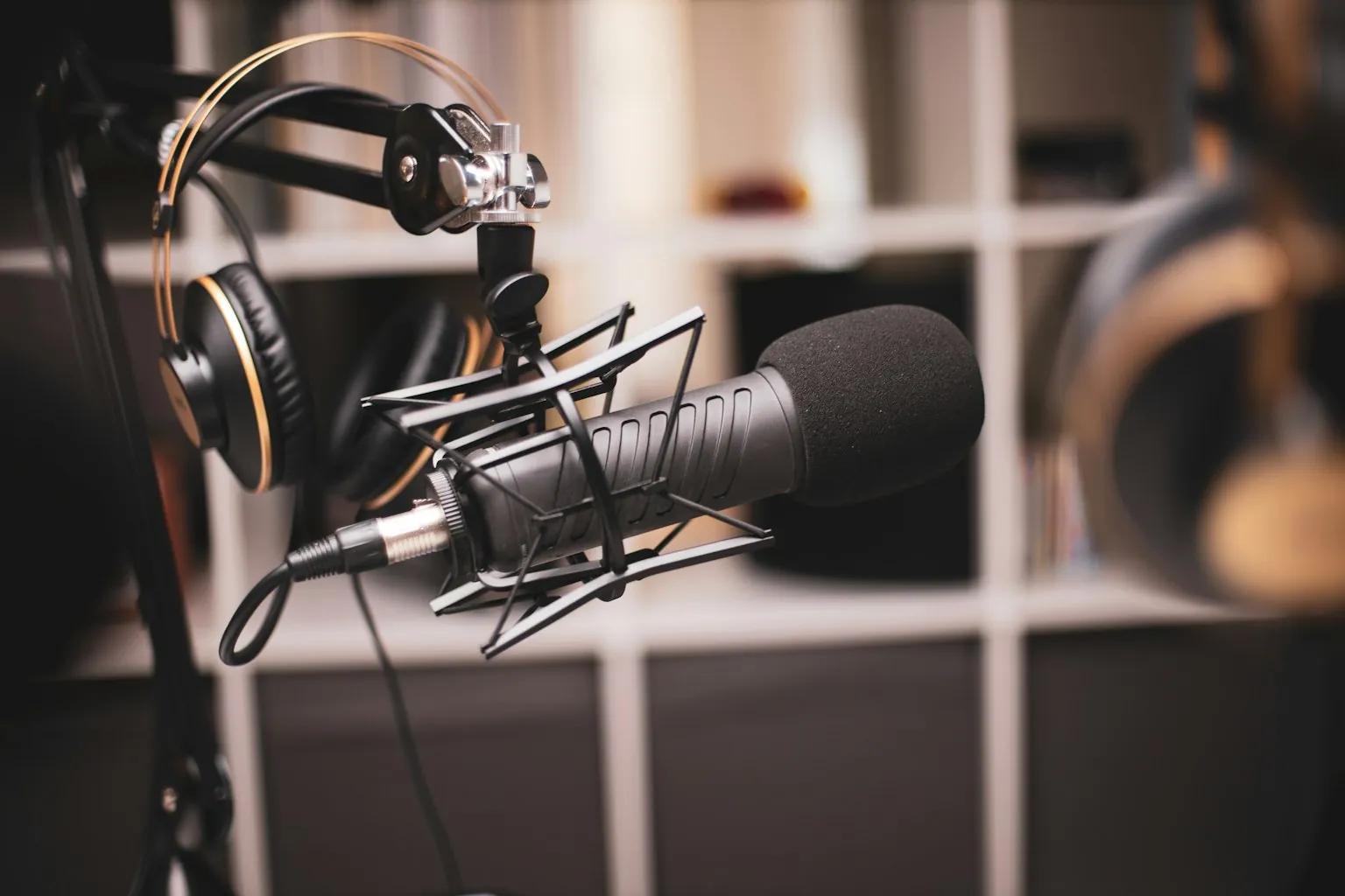 Professional broadcast microphone with studio headphones in a radio station recording environment ready for a Classic Hits show