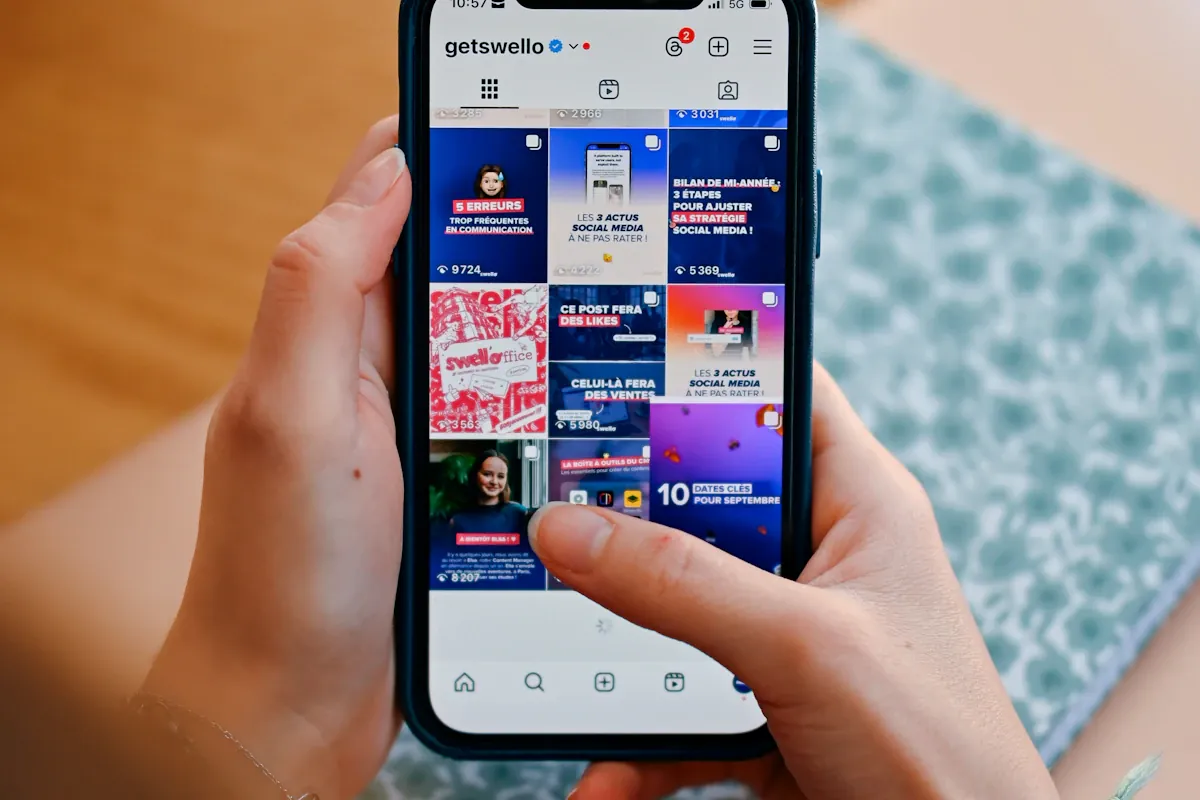 Hands holding a smartphone displaying a social media feed representing multi-platform content distribution for radio show promotion