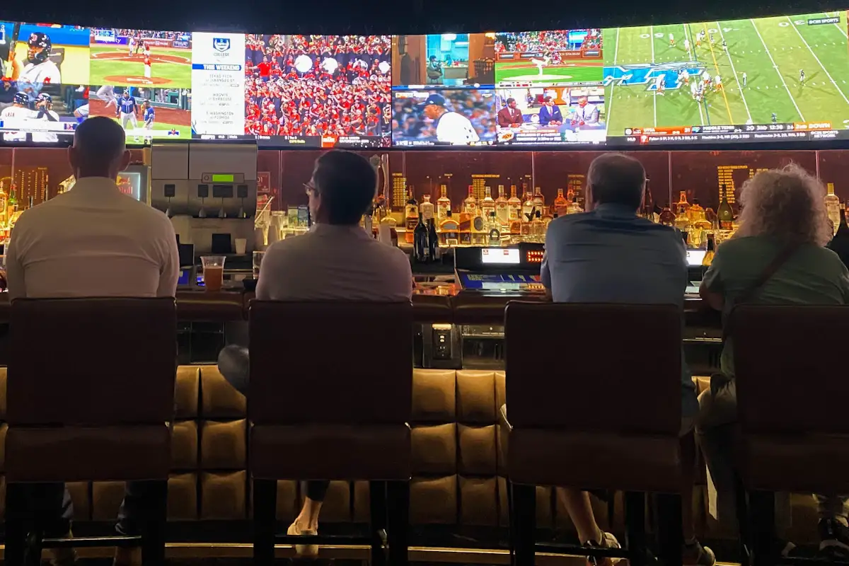 Group of fans gathered at a sports bar watching a game on TV representing radio station remote broadcast and Opening Day promotion opportunities