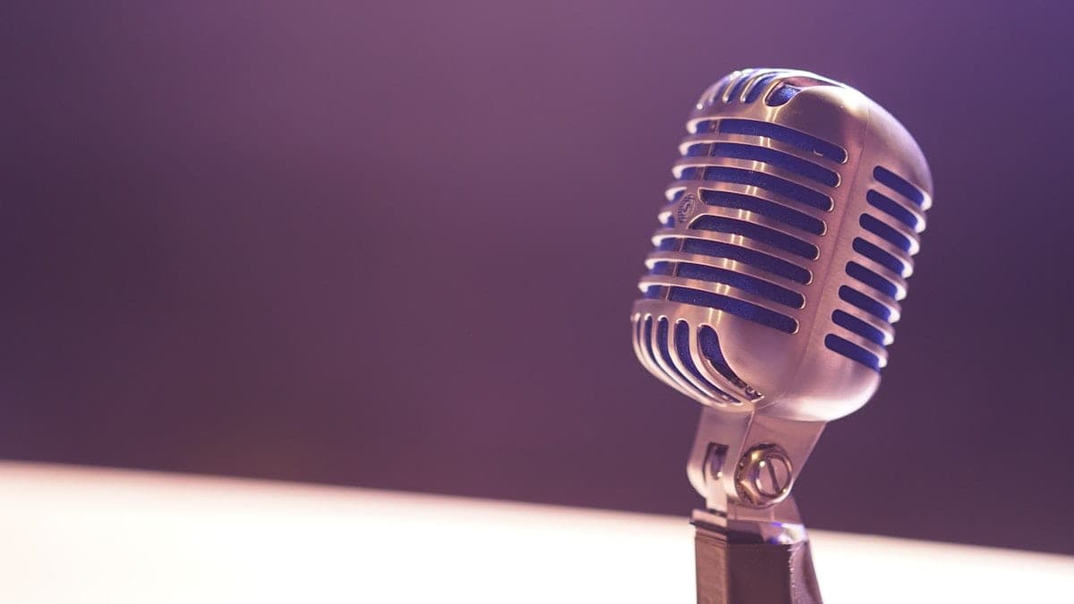 Professional broadcast microphone with dramatic lighting in a radio studio setting for morning show content