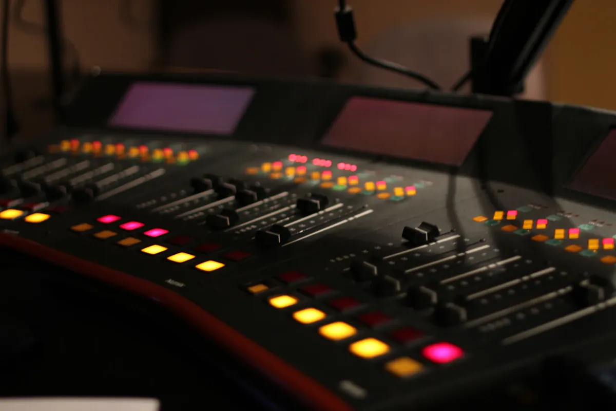 Modern black and red audio mixer control panel in professional radio studio