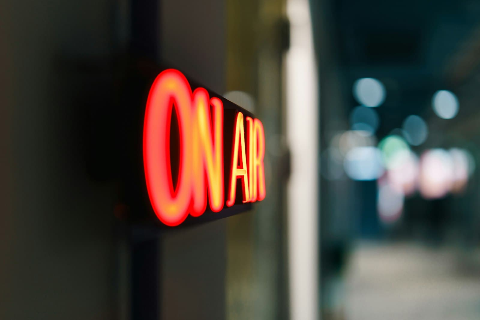 Red On Air sign glowing in a radio broadcast studio